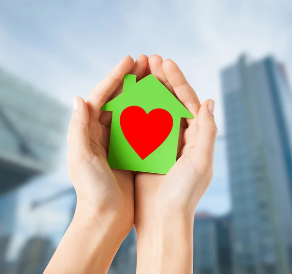 Hands holding green paper house — Stock Photo, Image