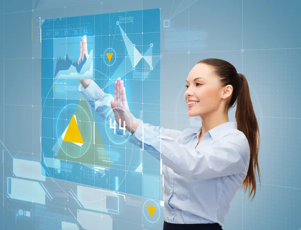 Smiling businesswoman working with virtual screen — Stock Photo, Image