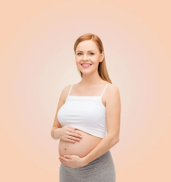 Feliz futura madre tocando su vientre — Foto de Stock