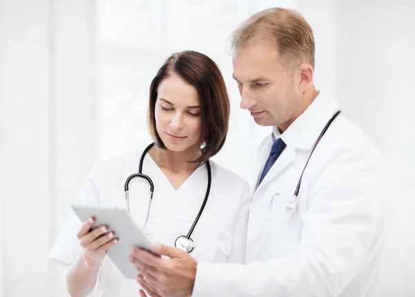 Два лікарі дивляться на планшетний ПК — стокове фото