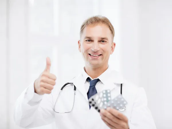 Male doctor with packs of pills — Stock Photo, Image