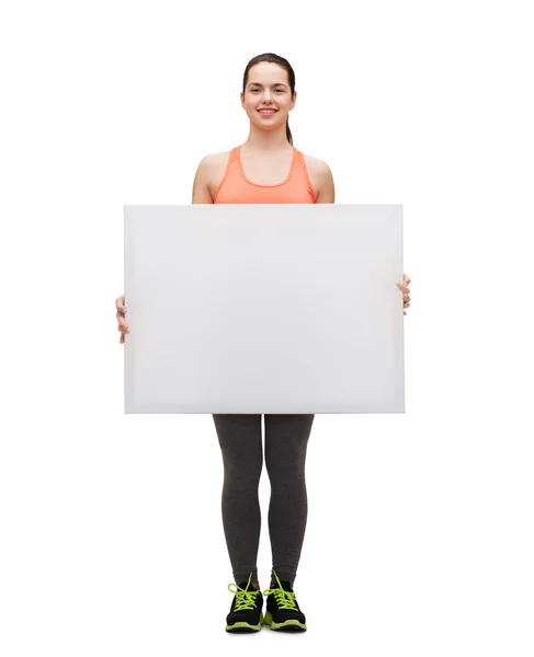 Teenage girl in sportswear with white board — Stock Photo, Image