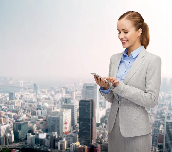 Young smiling businesswoman with smartphone — Stock Photo, Image