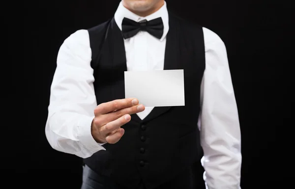 Dealer holding white card — Stock Photo, Image