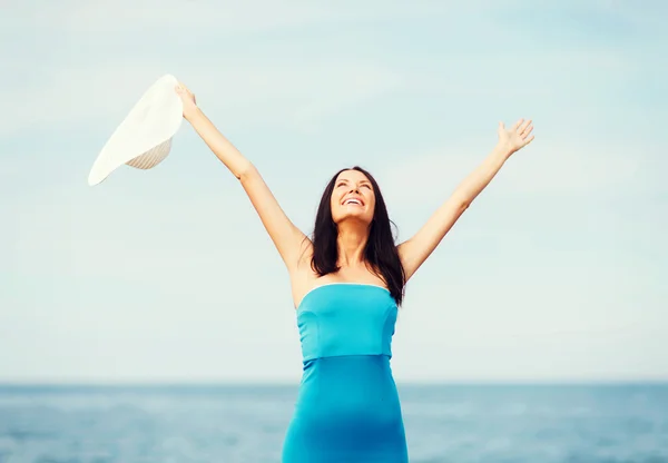 Girl with hands up on the beach — Stock Photo, Image