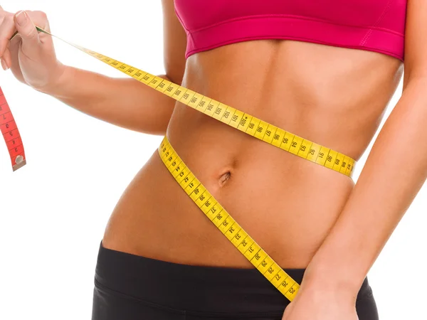 Close up of trained belly with measuring tape — Stock Photo, Image