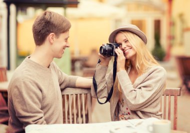 Couple taking photo picture in cafe clipart