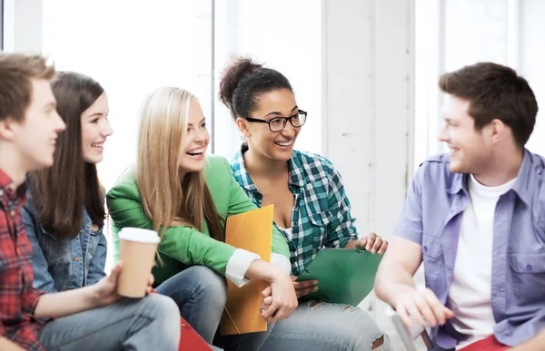 Students communicating and laughing at school — Stock Photo, Image