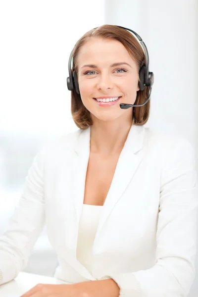 Opérateur de ligne téléphonique féminine souriante avec écouteurs — Photo