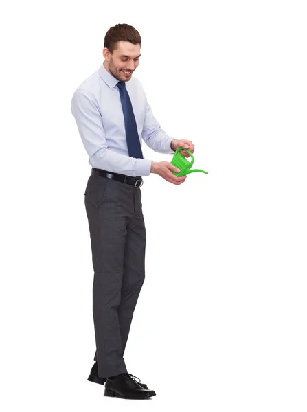 Handsome buisnessman with green watering can — Stock Photo, Image