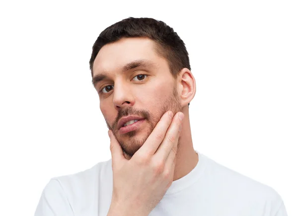 Beautiful calm man touching his face — Stock Photo, Image