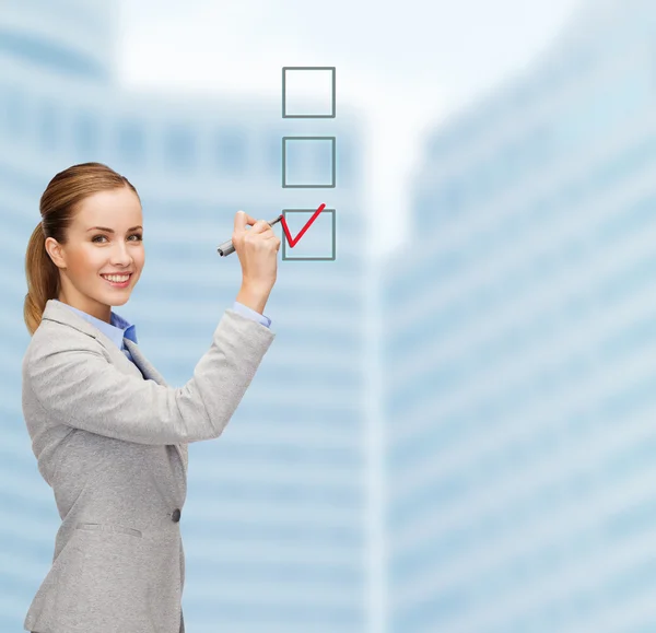 Businesswoman writing something in air with marker — Stock Photo, Image