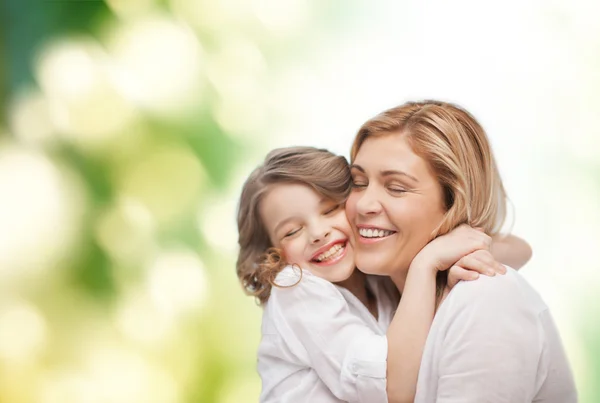 Happy mother and daughter hugging — Stock Photo, Image