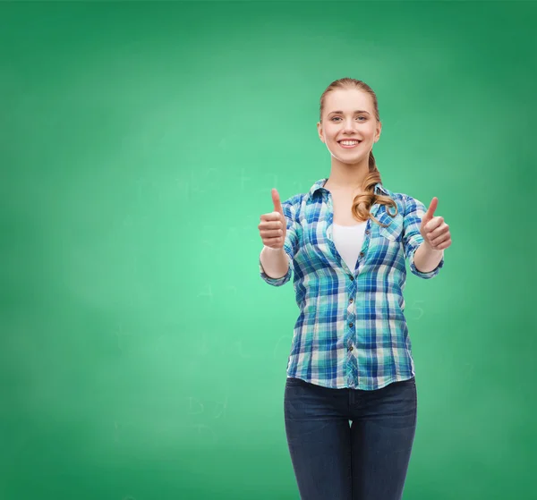 Young woman in casual clothes showing thumbs up — Stock Photo, Image