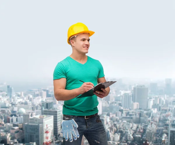 Smiling man in helmet with clipboard — Stock Photo, Image