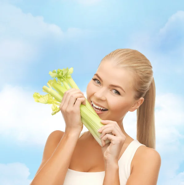 Woman biting piece of celery or green salad — Stock Photo, Image