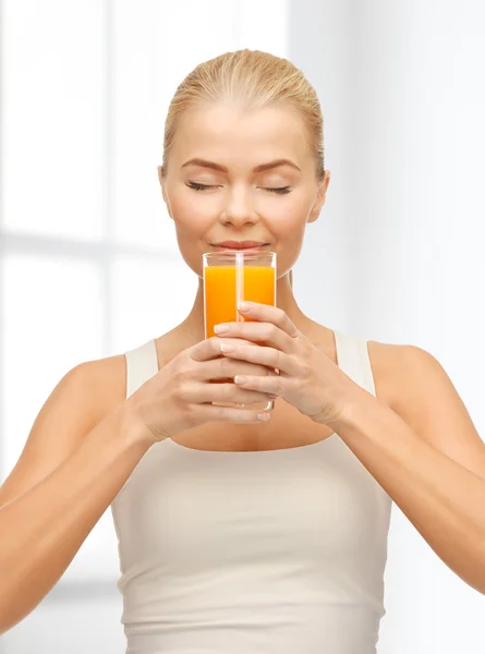 Jovem mulher bebendo suco de laranja — Fotografia de Stock