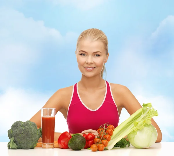 Smiling young woman with organic food on the table — Stock Photo, Image