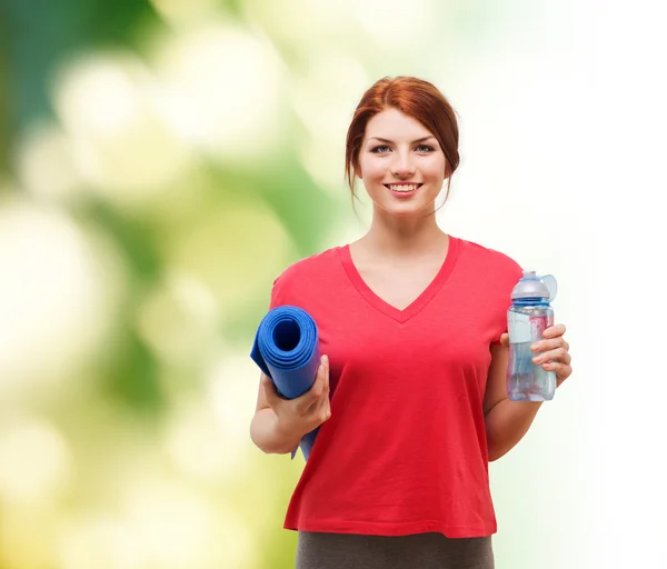 Chica sonriente con botella de agua después de hacer ejercicio — Foto de Stock