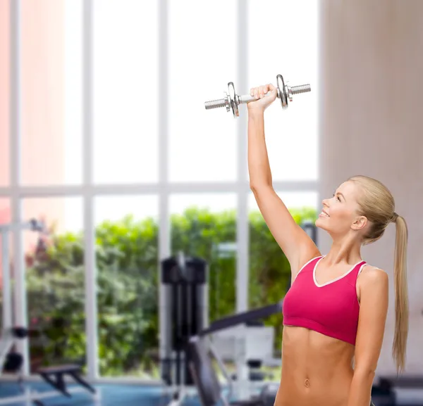 Smiling woman with heavy steel dumbbell — Stock Photo, Image