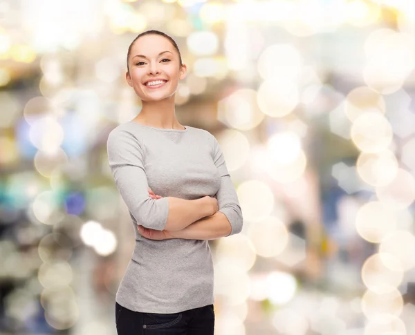 Smiling asian woman over with crossed arms — Stock Photo, Image