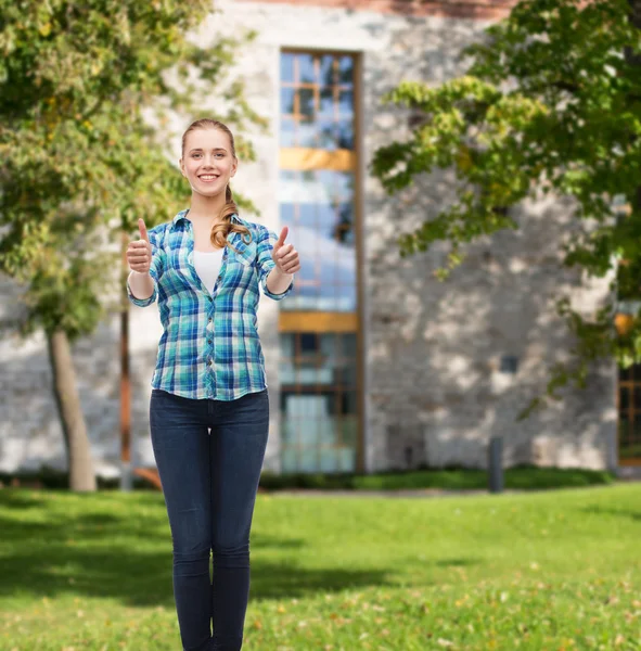 Young woman in casual clothes showing thumbs up — Stock Photo, Image