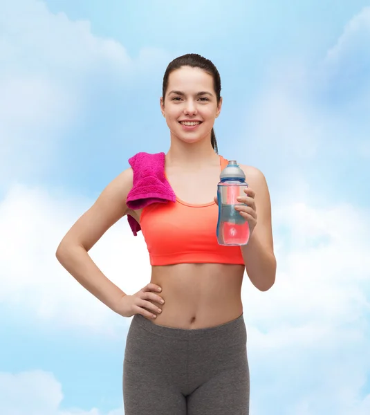 Femme sportive avec serviette et bouteille d'eau — Photo