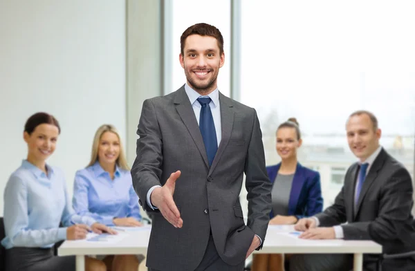 Businessman with open hand ready for handshake — Stock Photo, Image