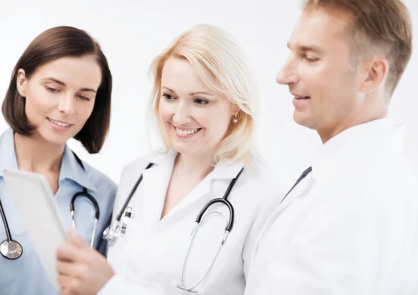 Doctors looking at tablet pc — Stock Photo, Image