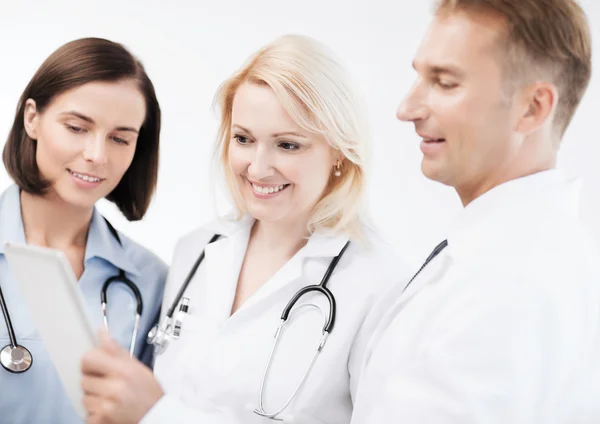 Doctors looking at tablet pc Stock Image