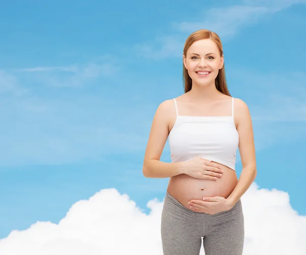 Happy budoucí matka dotýká její břicho — Stock fotografie