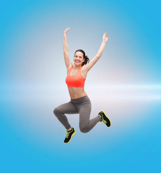 Sporty teenage girl jumping in sportswear — Stock Photo, Image