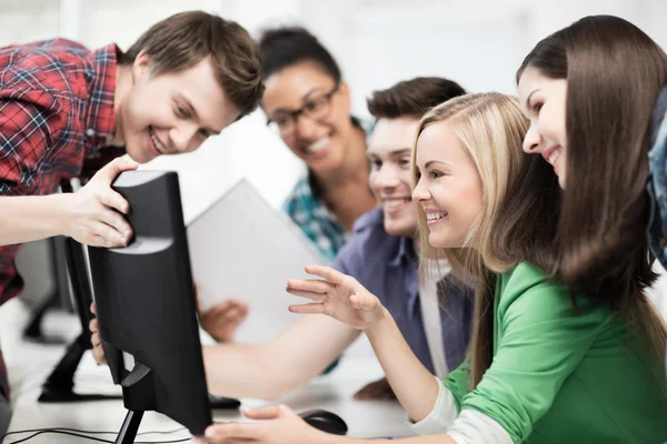 Students looking at computer monitor at school — Stock Photo, Image