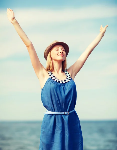 Girl with hands up on the beach — Stock Photo, Image