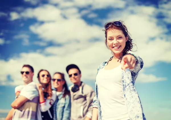 Teenage girl with headphones and friends outside — Stock Photo, Image