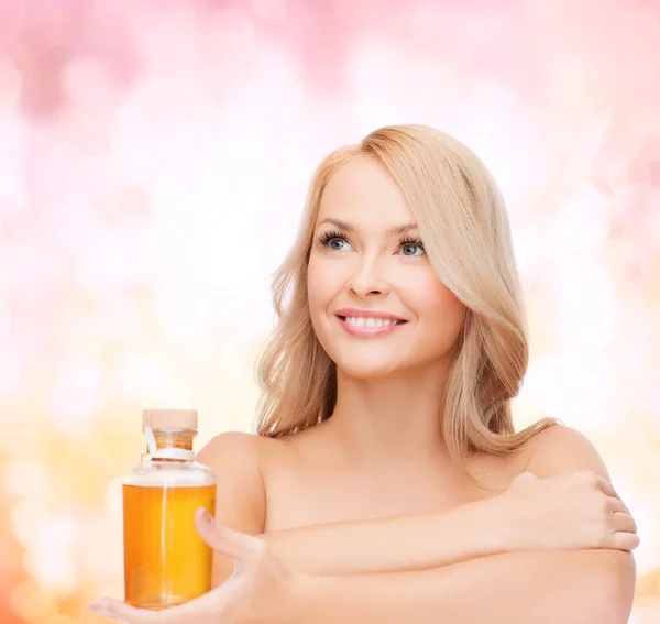 Happy woman with oil bottle — Stock Photo, Image