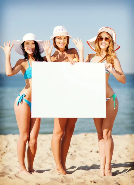 Girls with blank board on the beach — Stock Photo, Image