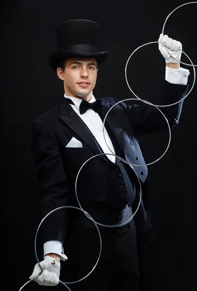 Magician showing trick with linking rings Royalty Free Stock Photos