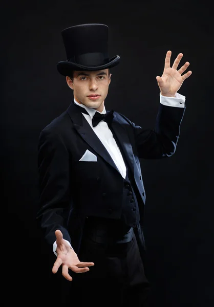 Magician in top hat showing trick Stock Image