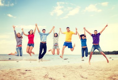 group of friends jumping on the beach clipart