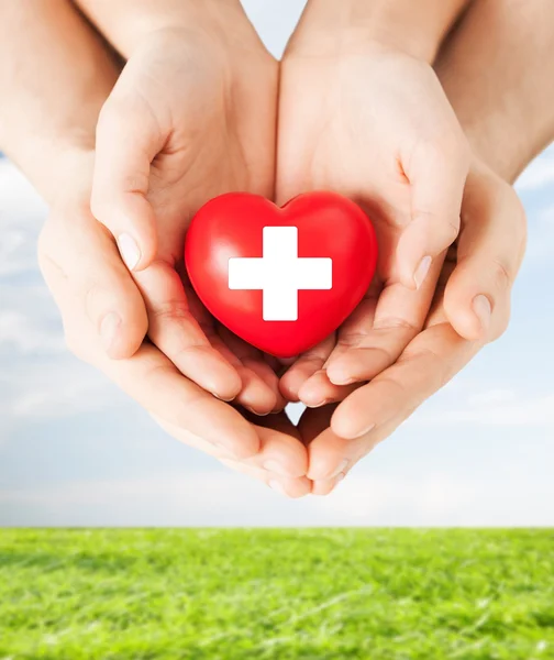 Male and female hands with red heart — Stock Photo, Image