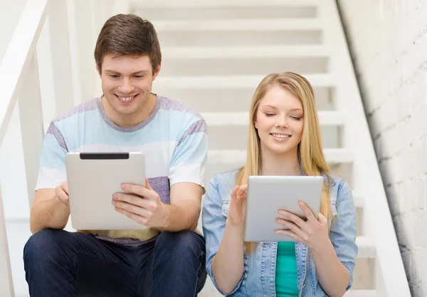 Smiling students with tablet pc computer — Stock Photo, Image