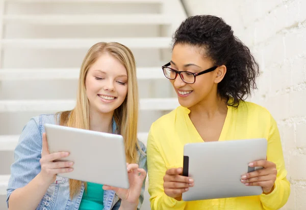 Smiling female students with tablet pc computer Stock Image