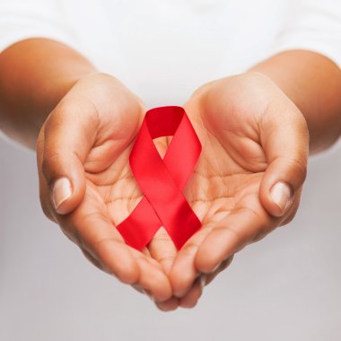 hands holding red AIDS awareness ribbon clipart