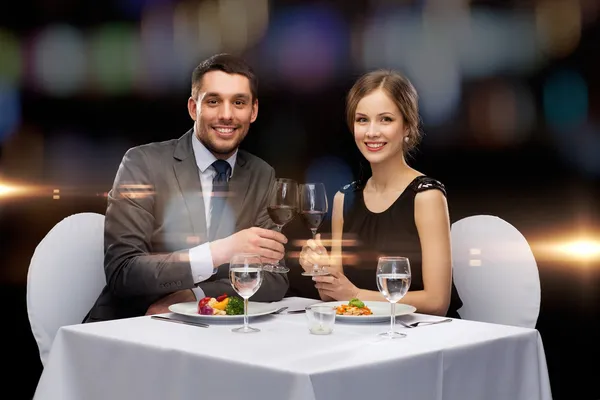 Lächelndes Paar isst Hauptgang im Restaurant — Stockfoto