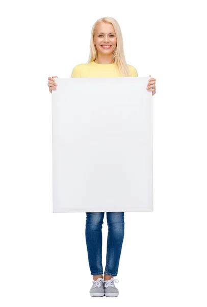 Smiling woman in sweater with blank white board — Stock Photo, Image