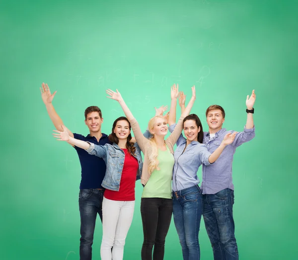 Group of smiling students waving hands — Stock Photo, Image