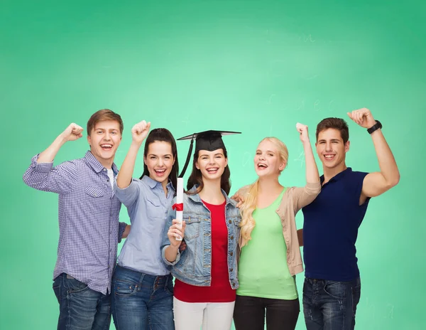 Group of standing smiling students with diploma — Stock Photo, Image