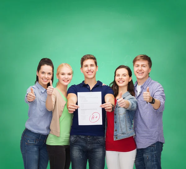 Group of students showing test and thumbs up — Stock Photo, Image