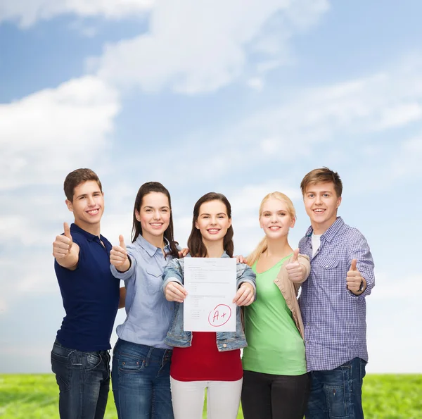 Group of students showing test and thumbs up — Stock Photo, Image